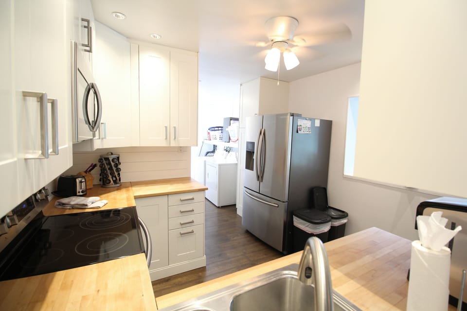View from Kitchen into the Laundry Room with French Door Refrigerator