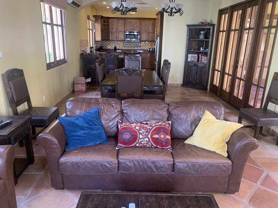 Three leather couches offer plenty of room and comfort to gather. Smart TV.
