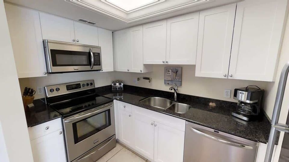 Updated kitchen with stainless steel appliances and granite counter top.