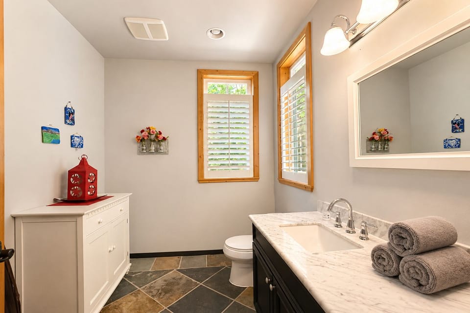 Main floor powder room with vanity and toilet.