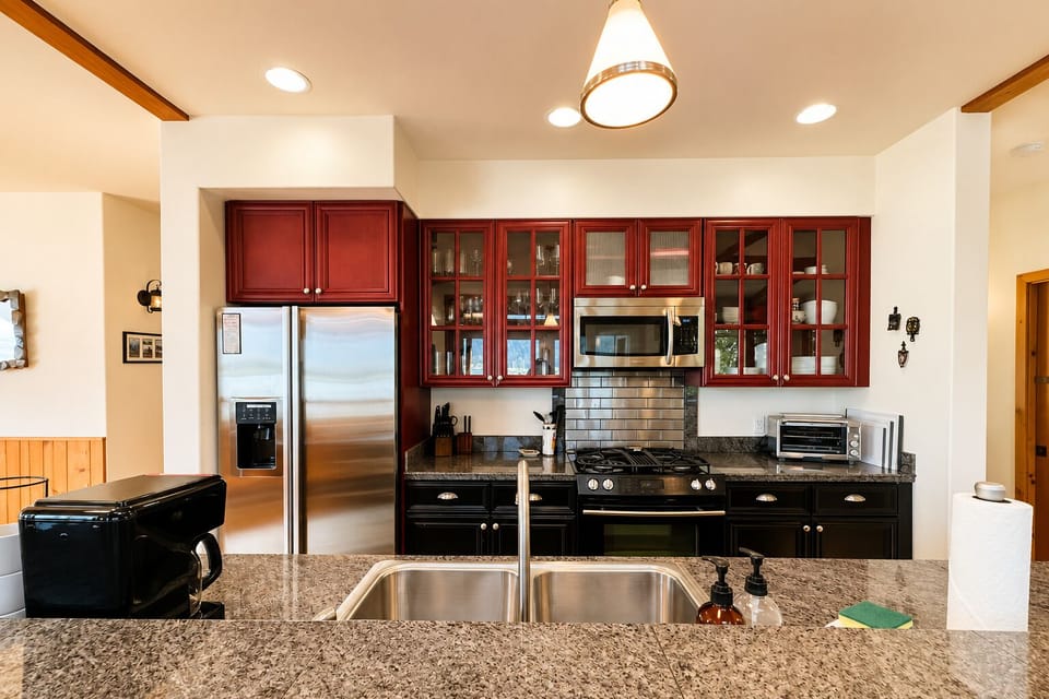Full Kitchen includes eat up bar, and all of the necessary comforts of a home kitchen for meal prep .