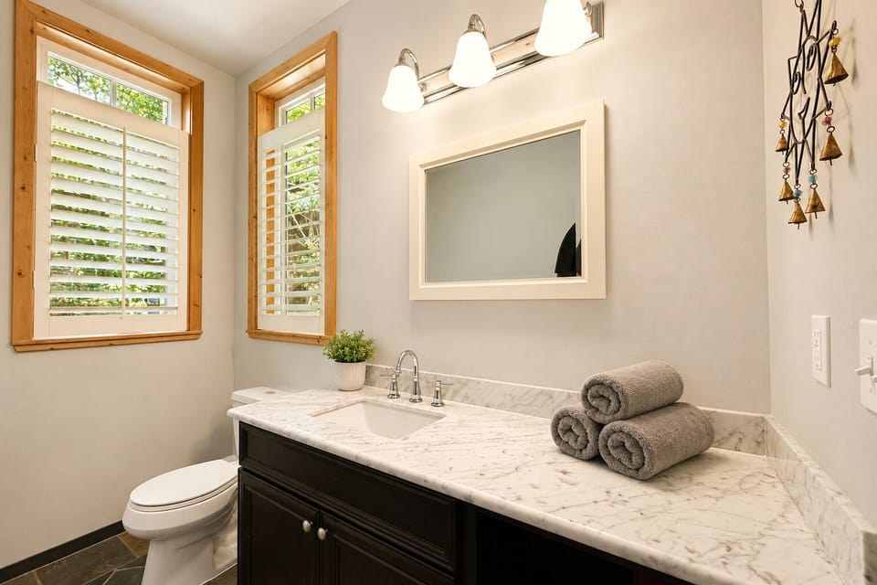 Main floor powder room with vanity and toilet.