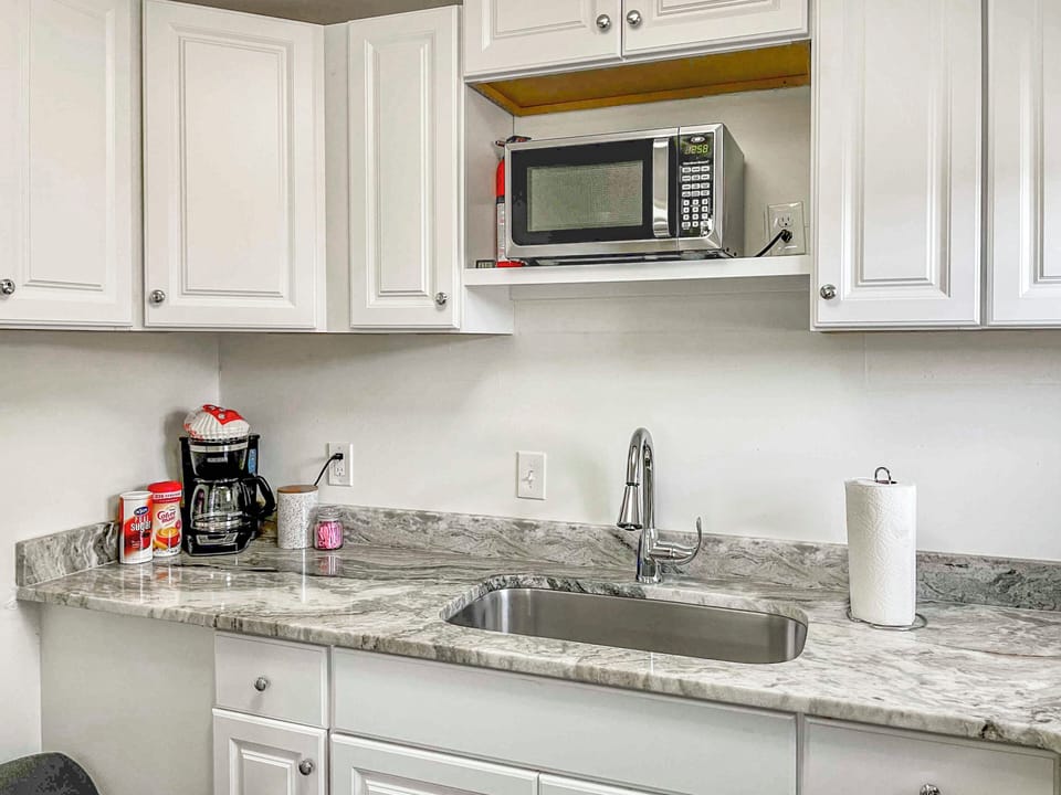 Full kitchen with drip coffee maker and coffee provided
