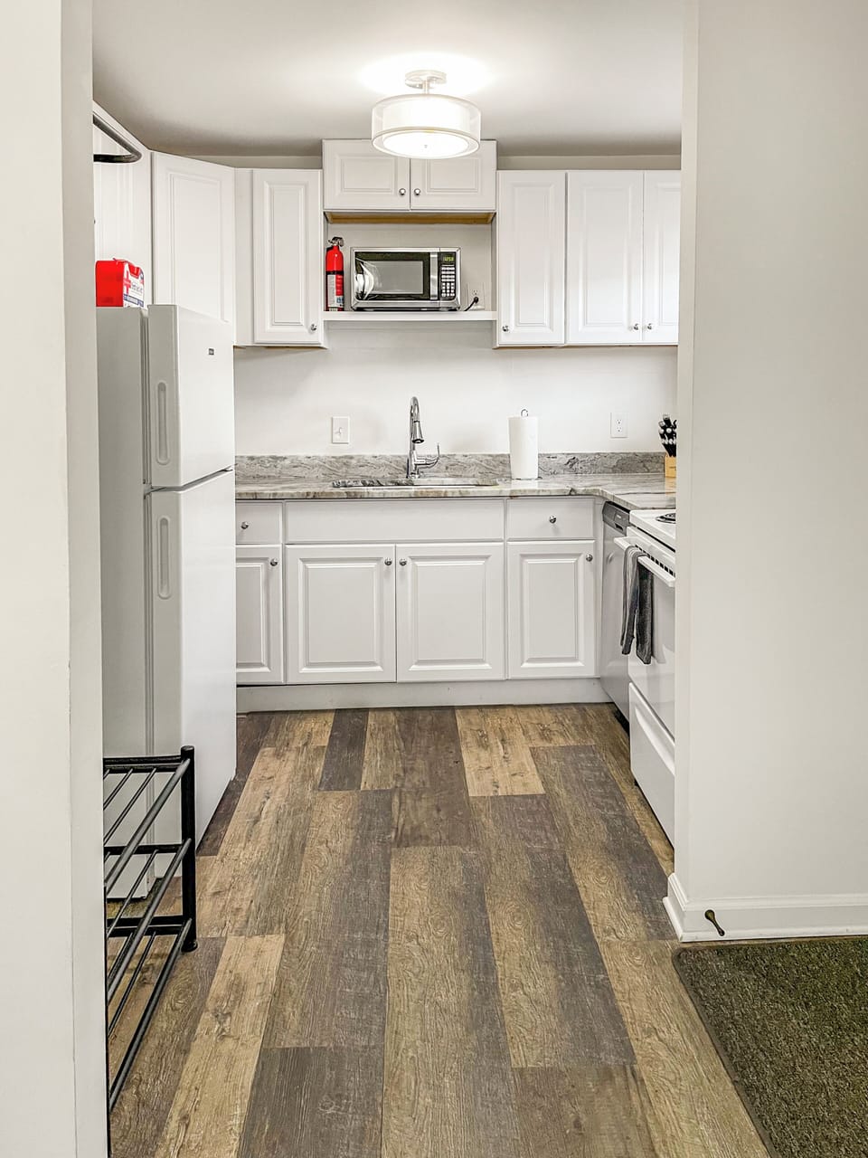 Full kitchen with refrigerator, stove, microwave, dishwasher, and full sink.