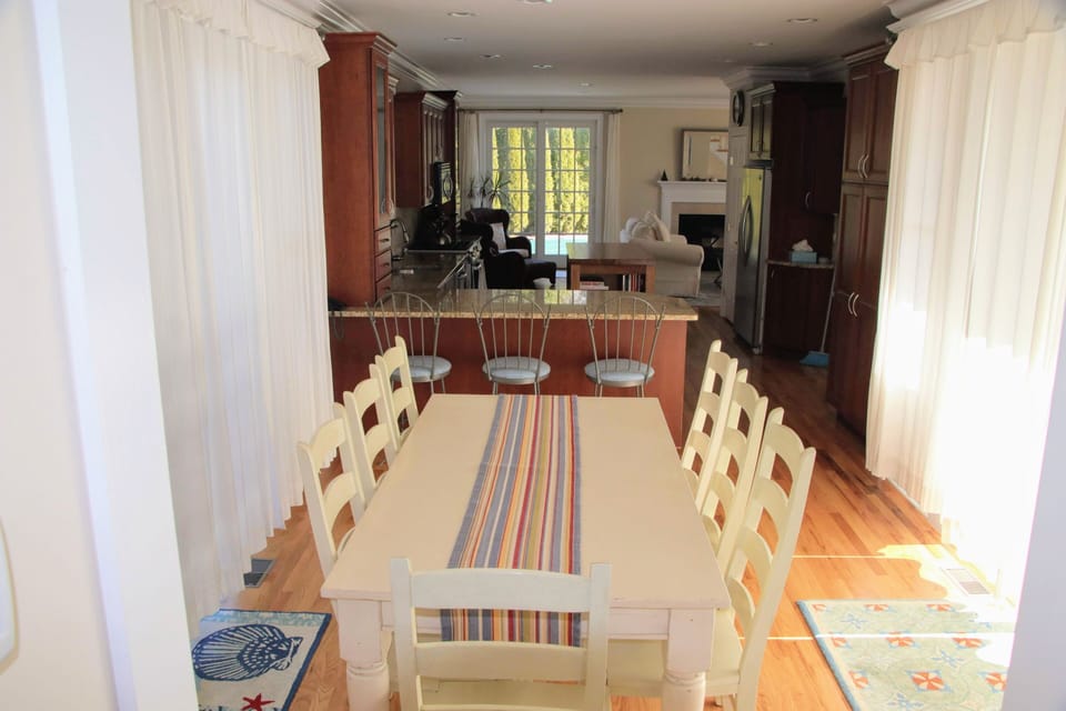 View-dining table (8 chairs) breakfast bar (3 stools) and kitchen to pool deck!