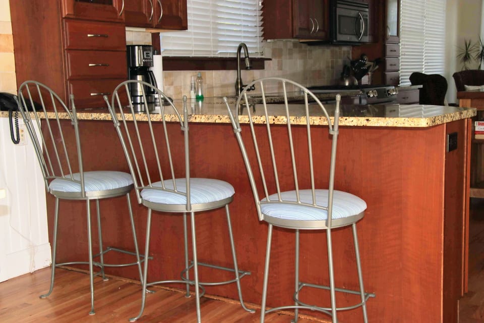 Fabulous, well stocked  kitchen with new gas range and  3 stools at the counter.