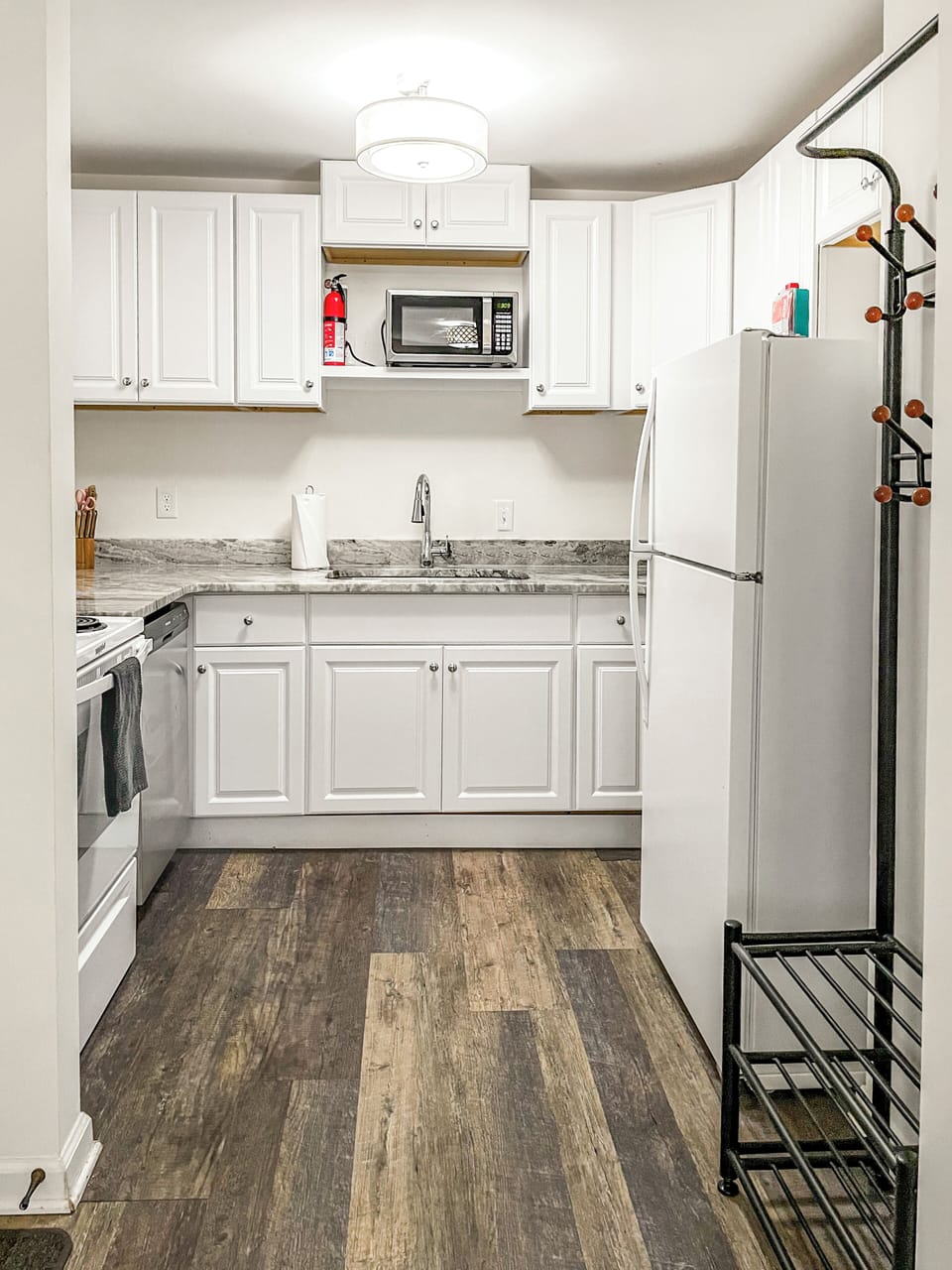 Full kitchen with refrigerator, stove, microwave, dishwasher, and full sink.