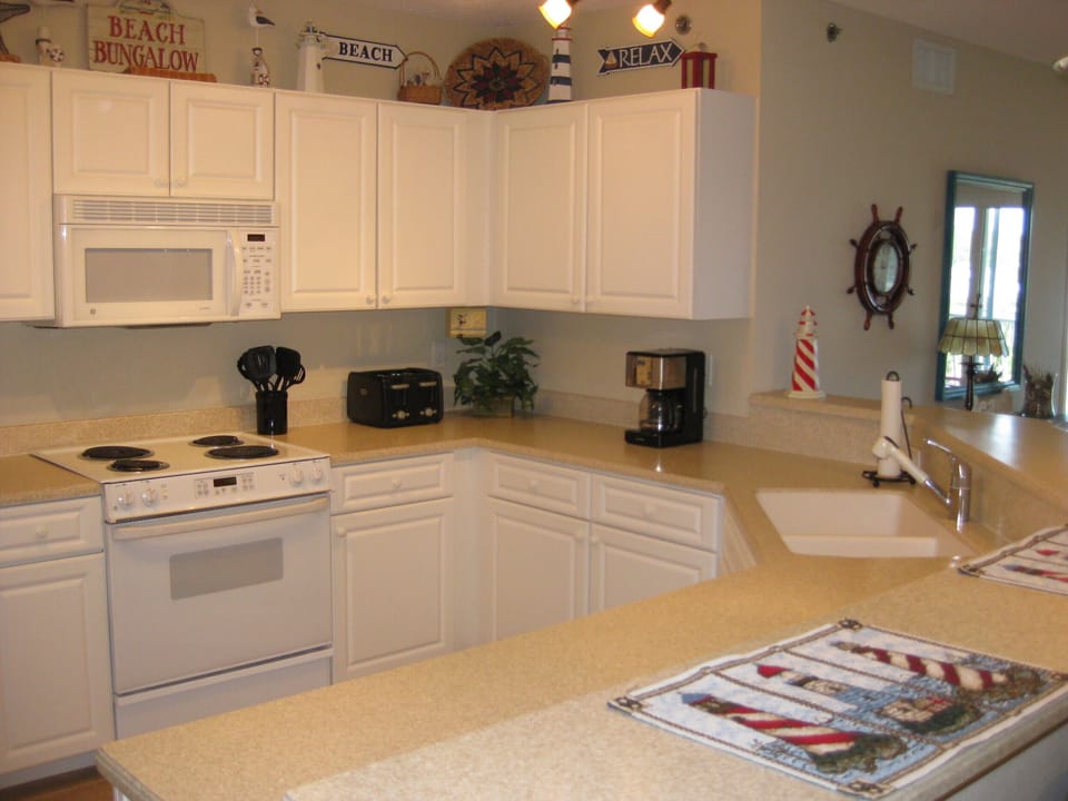 Corian counter tops and clean white cabinets 