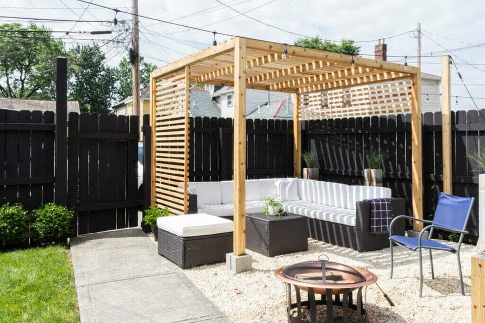 Outdoor sectional under a pergola in the backyard + fire pit
