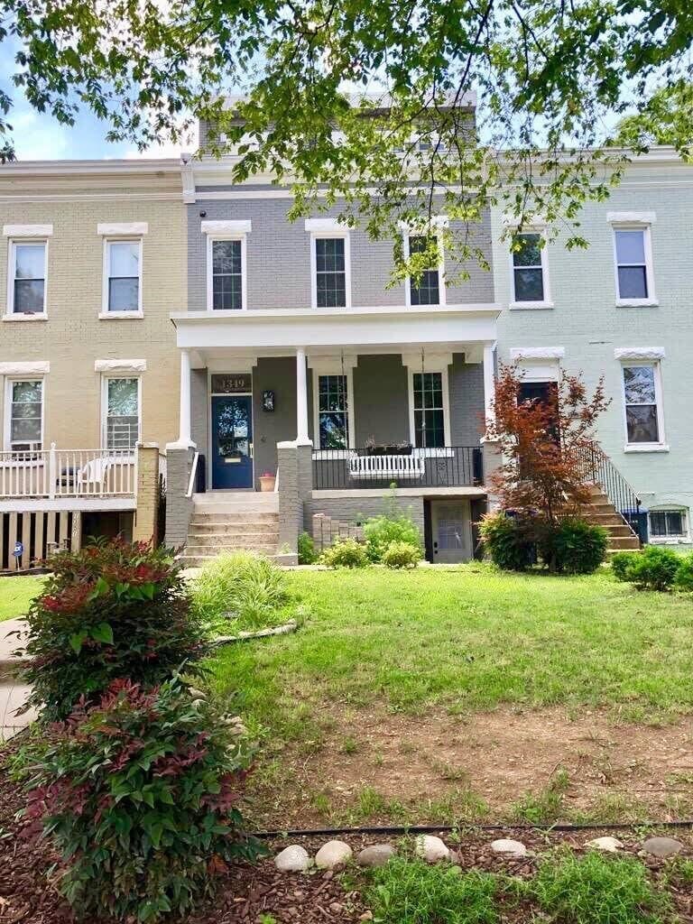 Curb appeal! Entrance is to the right of the staircase. 