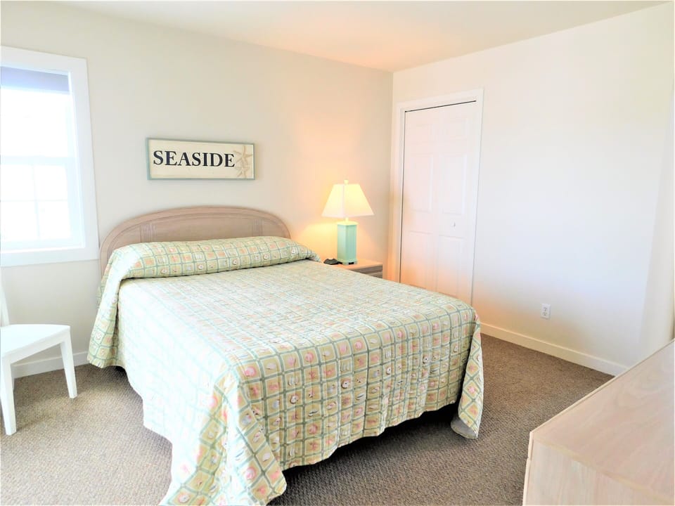 7 South Carolina Avenue - Bedroom Wall Decor - Alternate view of the bedroom highlighting the wall art above the headboard and the closet door.