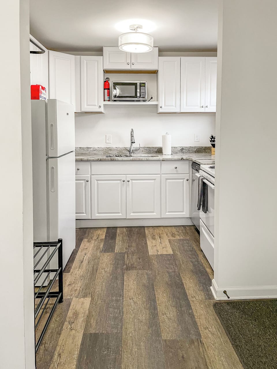 Full kitchen with refrigerator, stove, microwave, dishwasher, and full sink.
