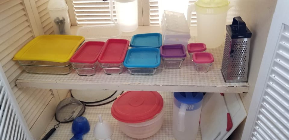 Cupboard with storage containers under counter top