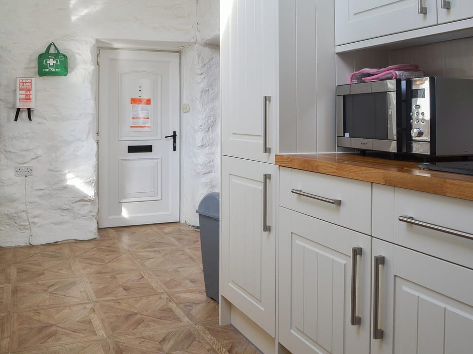 Well equipped and well appointed kitchen | Porth Colmon Farmhouse, Porth Colmon, near Pwllheli