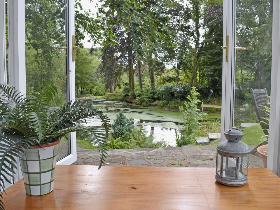 Conservatory in the grounds with lake view | Ivy Cottage, Drefach Felindre, near Newcastle Emlyn