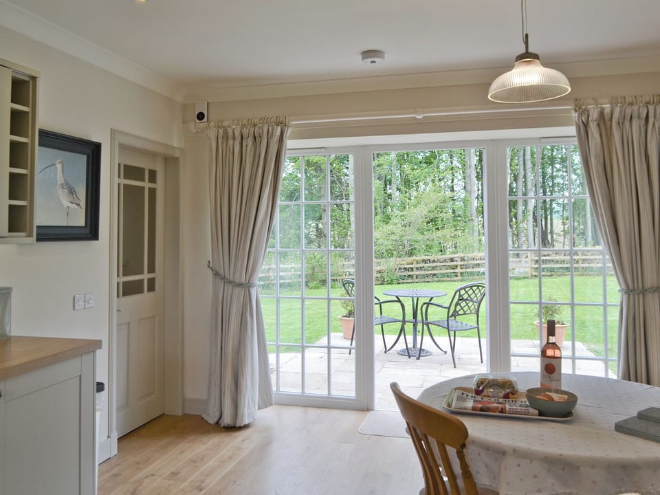 French doors from kitchen diner to sitting-out-area | Curlew Cottage - Strathisla Farm Cottages, Meigle