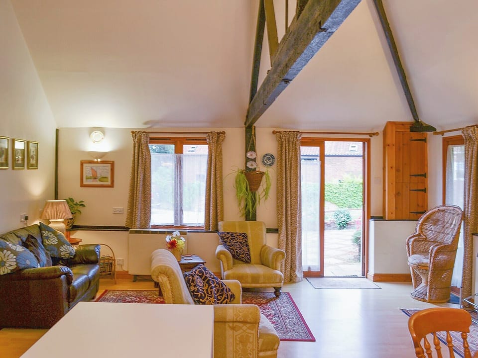 Comfortable open plan living area with exposed woodwork | Church Farm Studio, Surlingham