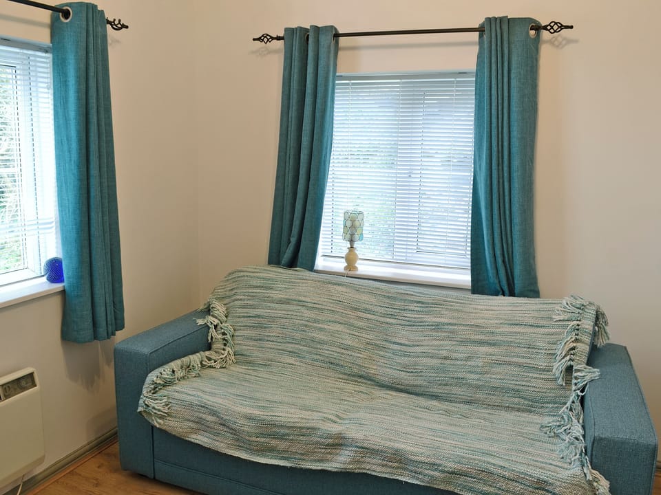 Cosy living area with double futon bed | The Pocket Watch, Seatown