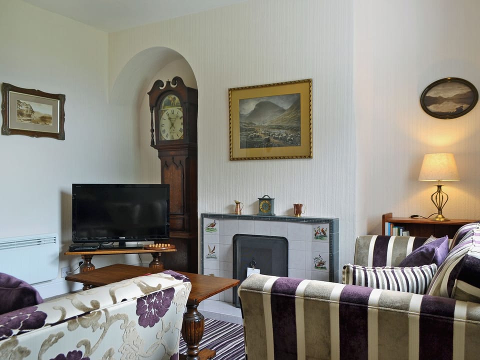 Homely living room with open fire | Howe Bridge House, Portinscale, near Keswick