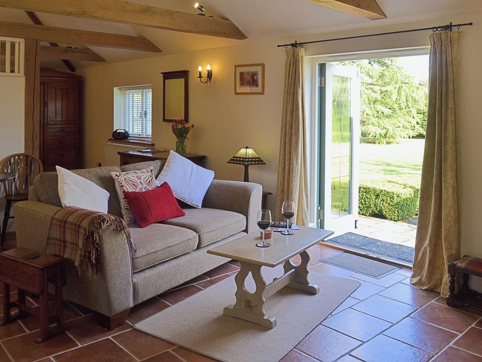 The tile floor complements the exposed beams and the living room opens directly onto the garden | The Stables - Canterbury Cottages, Shatterling, near Canterbury 