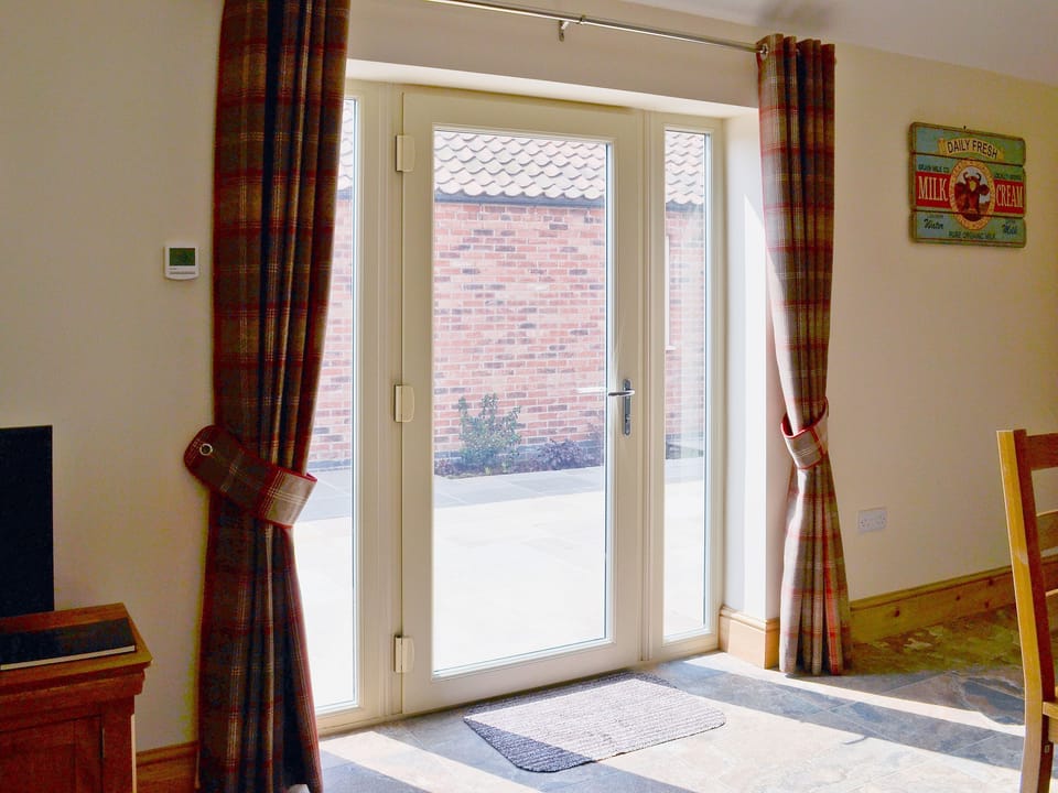 French doors opening on to the courtyard area | The Parlour - Dunstall Lodge Barns, Sutton-on-Trent