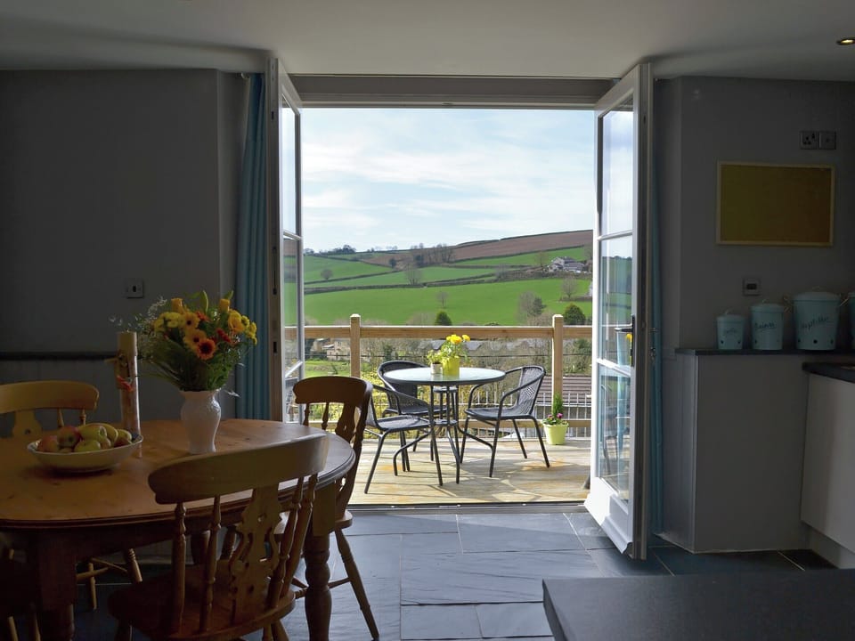 Kitchen/dining area with French doors leading to balcony | The Old Classroom, St Neot, near Liskeard