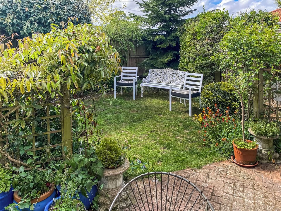 Enclosed garden with additional seating | Overland Cottage, Holt