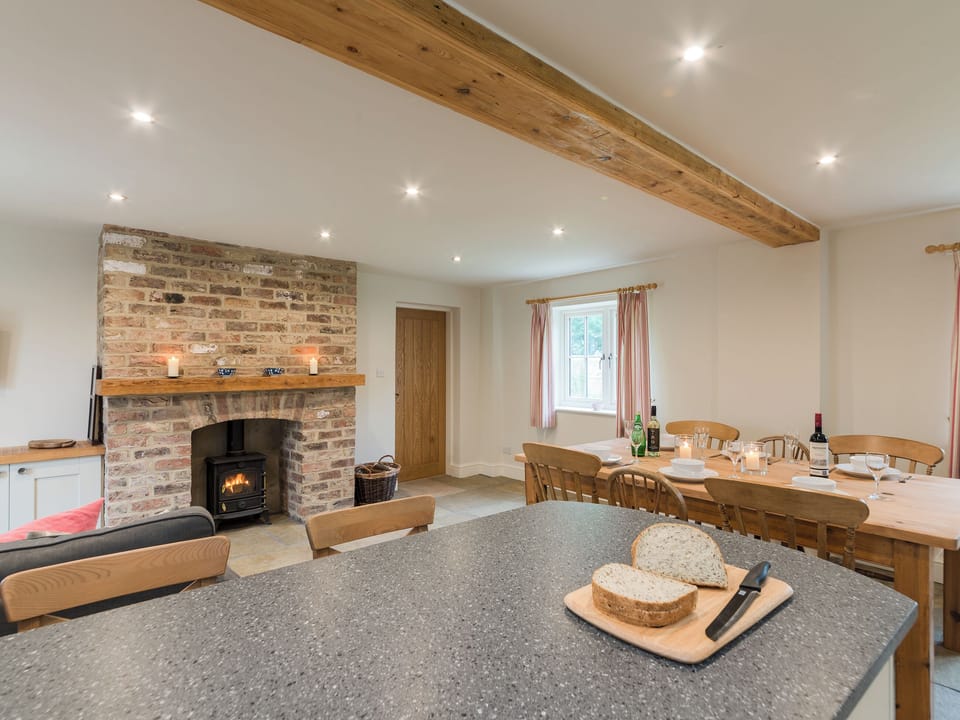 Open plan living space with exposed brickwork and a well-equipped kitchen and dining area | White Lodge Cottage, Carlton Miniott, near Thirsk