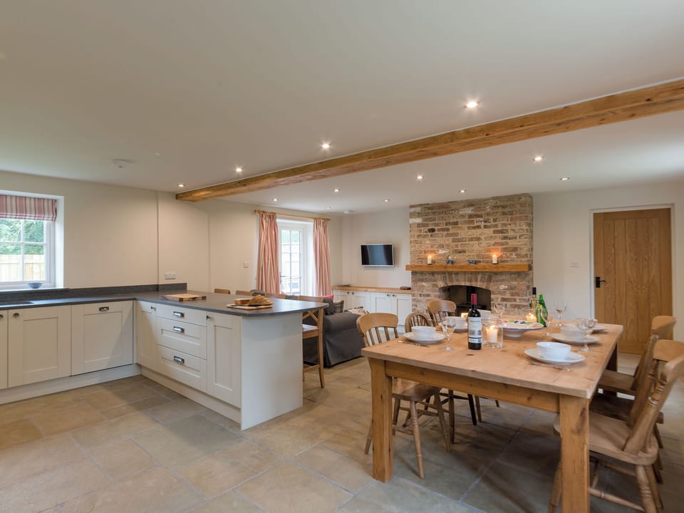 Open plan living space with exposed brickwork and a well-equipped kitchen and dining area | White Lodge Cottage, Carlton Miniott, near Thirsk