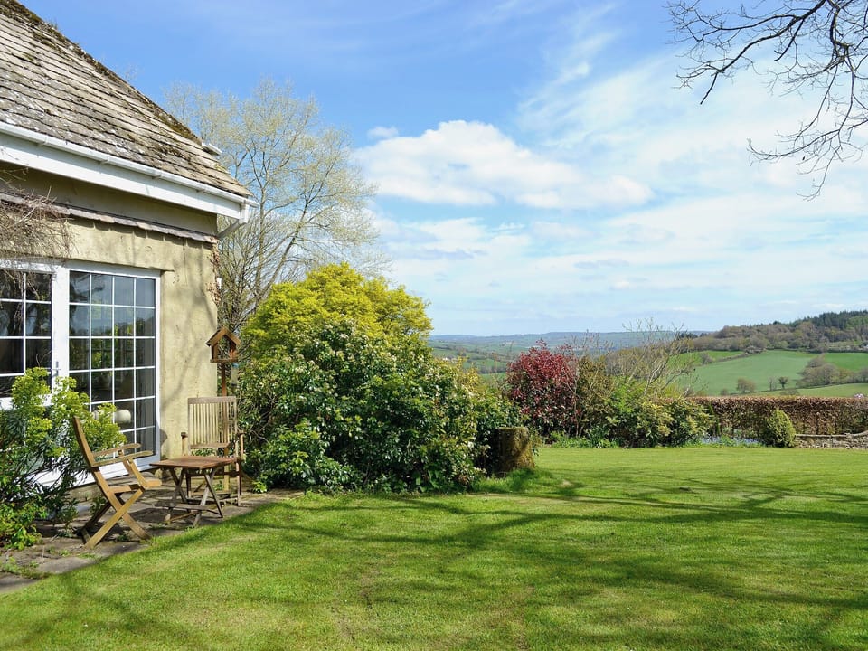 Shared enclosed small lawned garden with patio and furniture | Burrow Farm Garden Retreat - Valley View - Burrow Farm Gardens Retreat, Dalwood, near Axminster