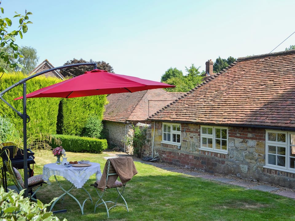 Enclosed garden with garden furniture and barbecue | Cowbeech Farm Cottage, Cowbeech, near Hailsham
