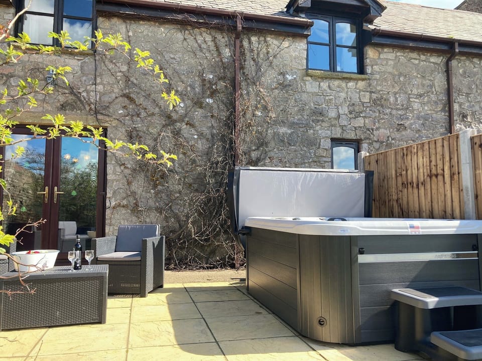 Patio area with hot tub | The Coach House, Trelawnyd, near Prestatyn
