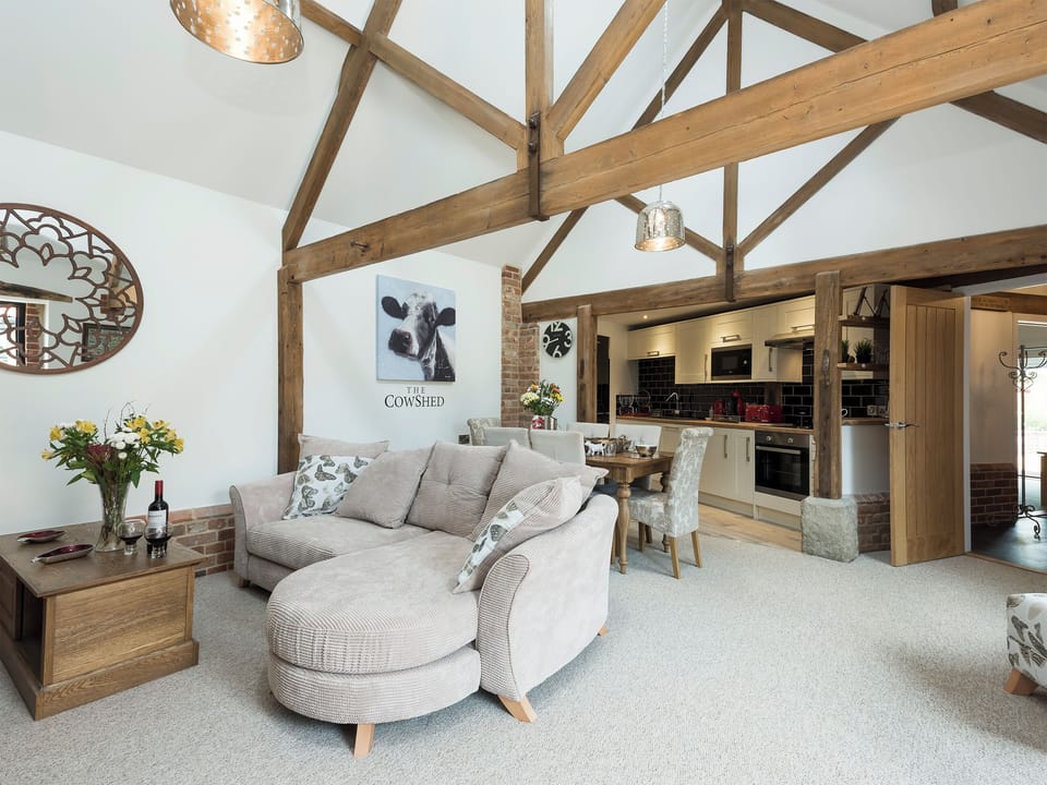 Spacious living area with exposed wood beams | The Cowshed, Horning, near Wroxham