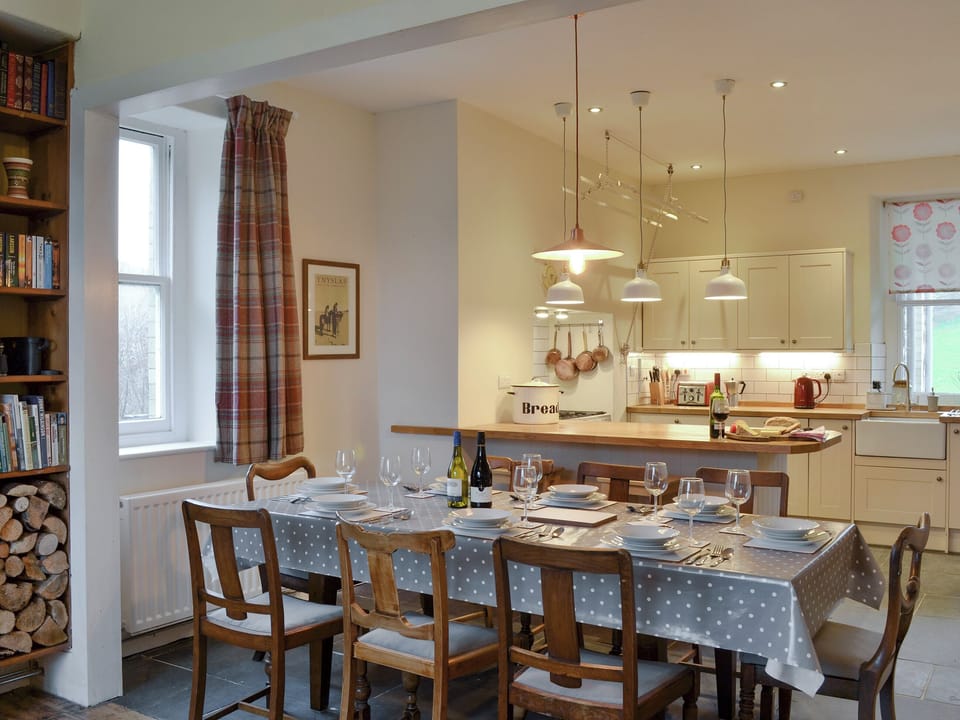 Large dining table in open plan room | Tyllwyd Farmhouse, Capel Bangor, near Aberystwyth