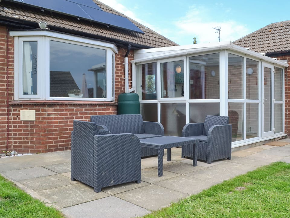 Paved patio area with furniture | Sea La Vie, Mundesley, near North Walsham