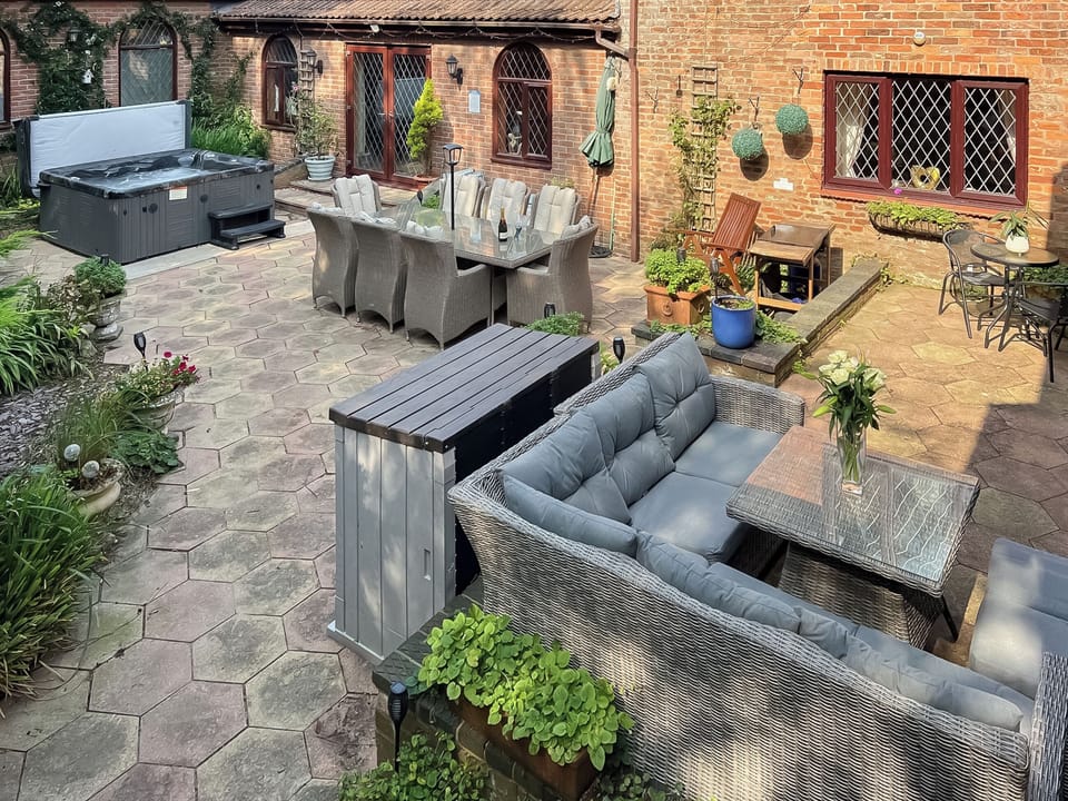 Patio area with hot tub and seating | Lambourne House - Ashtree Court, Skegness