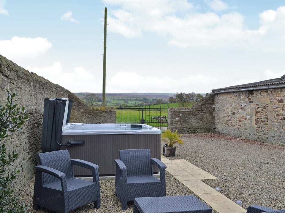Relax in the private hot tub whilst looking out over the rolling countryside | The Cottage at Wilson House, Barningham, near Richmond