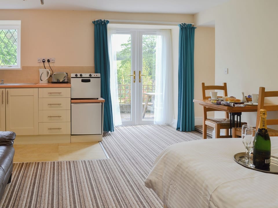 Delightful open plan living area with French doors to the garden | Lee Studio - Trimstone Manor Cottages, Trimstone, near Woolacombe