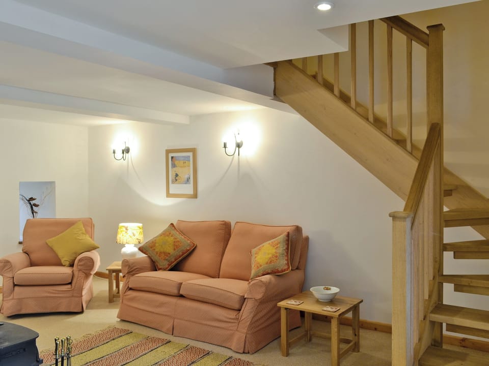 Cosy lounge with access to stairs to upper level | Honey Cottage - Bramble Cottage and Honey Cottage, Newland, near Coleford