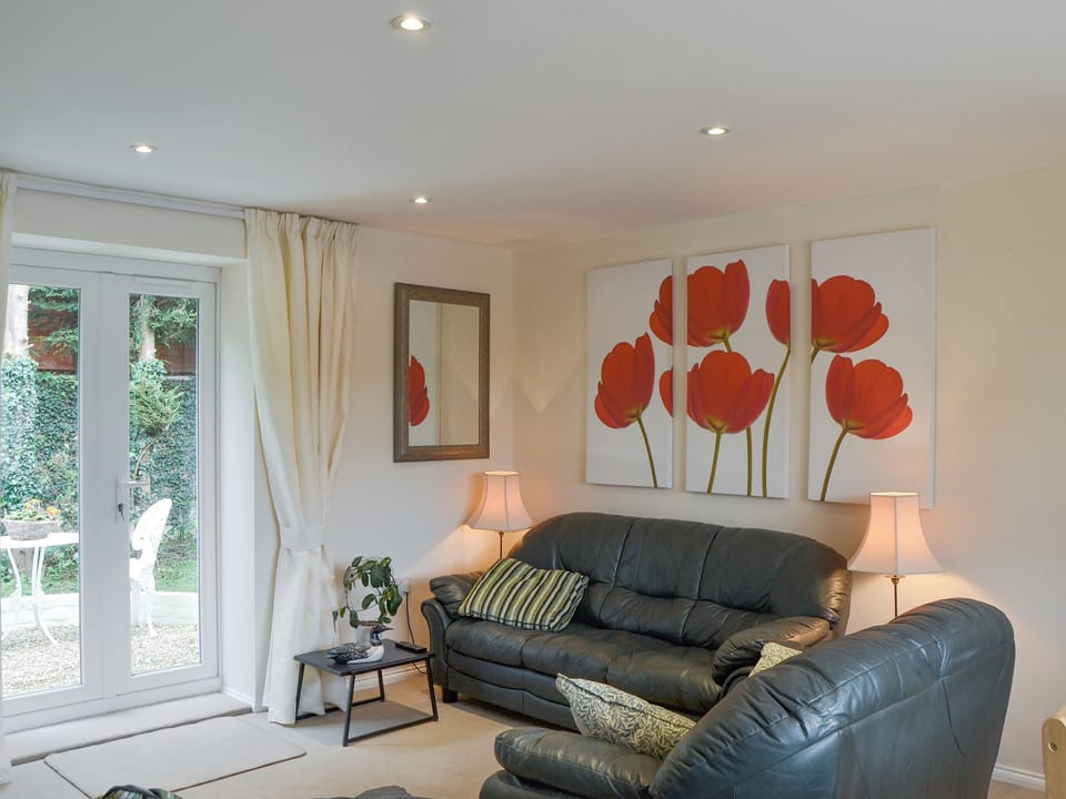 Attractive living area with French doors to patio area | Stable Cottage, Gunville, near Newport