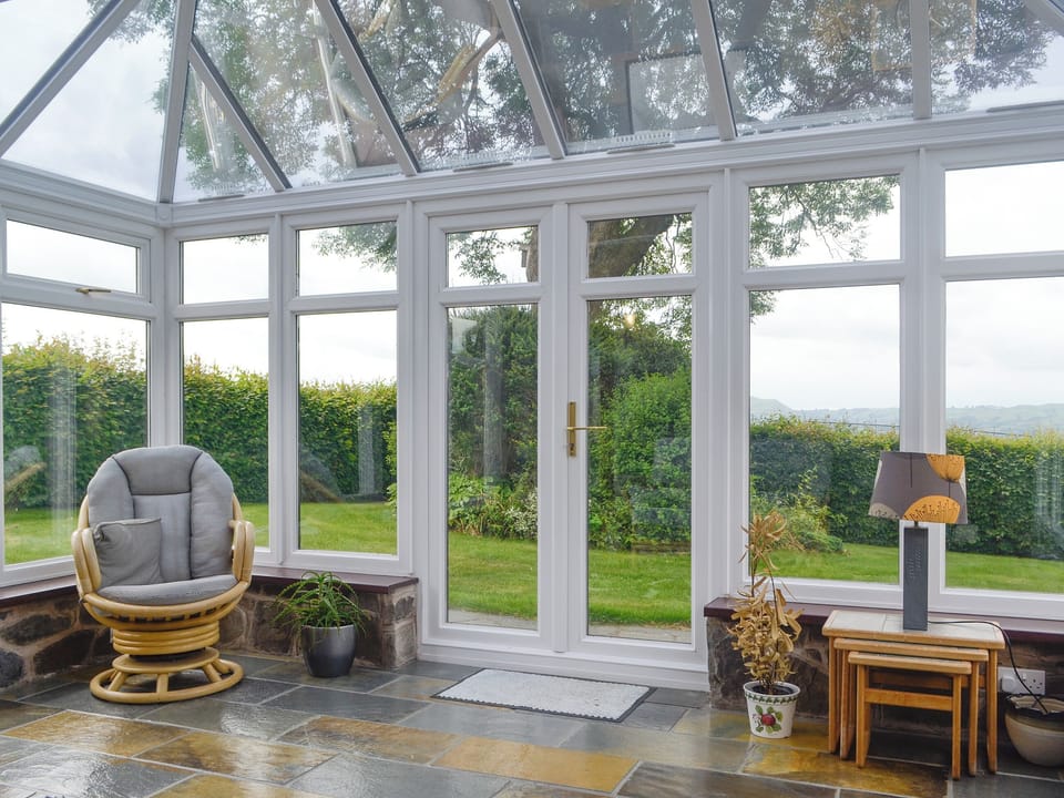 Spacious conservatory with access to garden | Green Lane Cottage, Aberhafesp, near Newtown