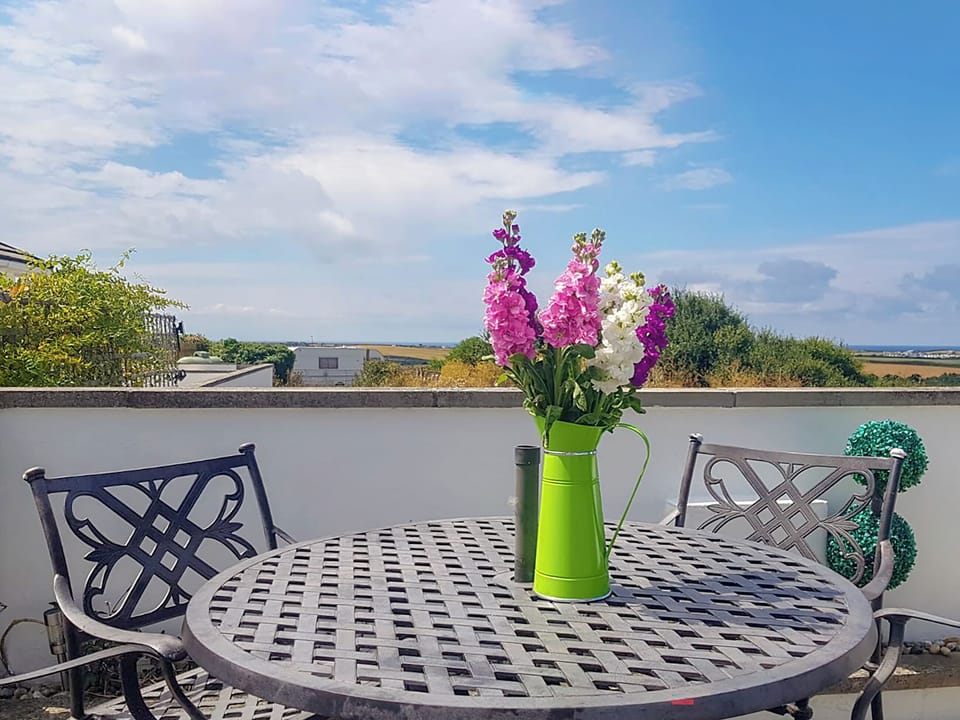 Patio with far reaching views | Trevone - Treginegar Cottages, St Merryn, near Padstow