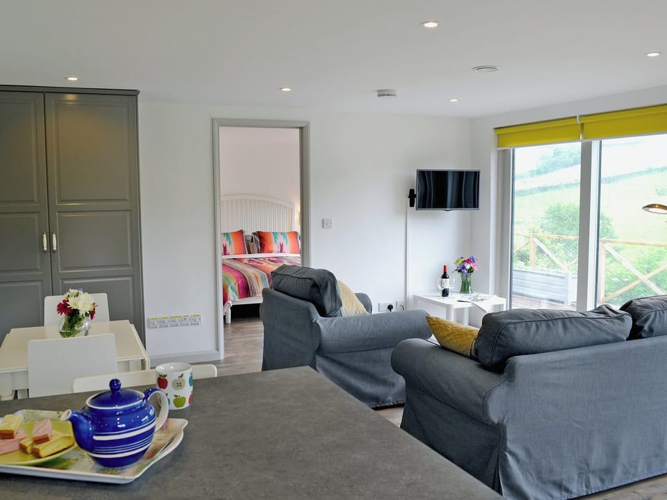 Comfortable double bedroom with doors leading to patio | The Shed with a View, Cadbury, near Crediton