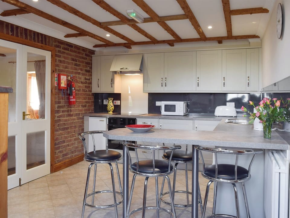 Stylish kitchen with breakfast bar | Yr Efail Argoed, Llanddowror, near Laugharne