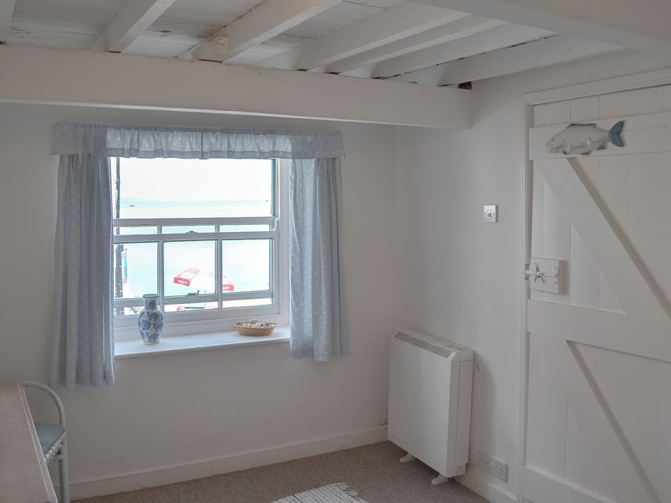 Beamed double bedroom with views out to sea | Beach Corner Cottage, Gorran Haven, near St Austell