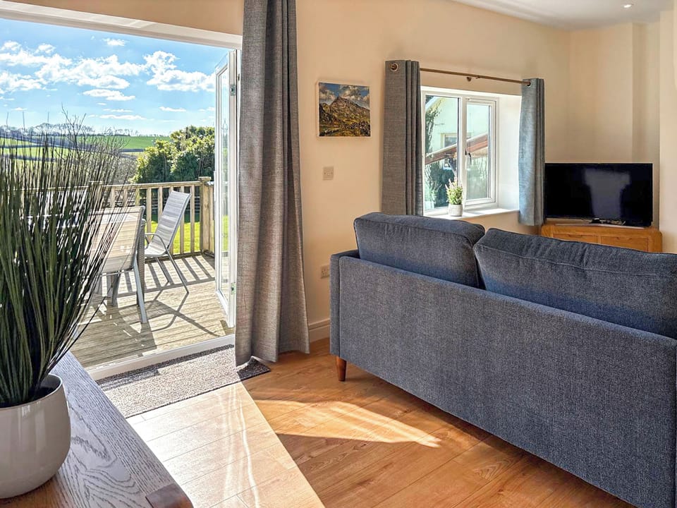 Living room leading to outside seating area | Spring Cottage, Kentisbury, near Barnstaple
