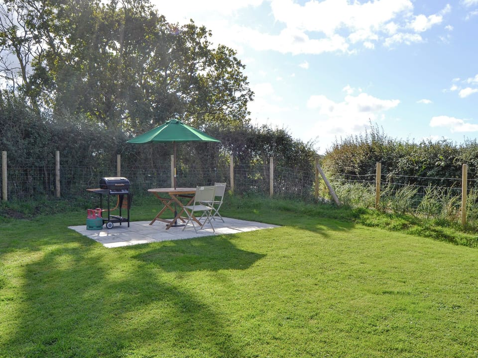 Enclosed lawned garden with outdoor seating and BBQ area | Southview, Porchfield, near Newport