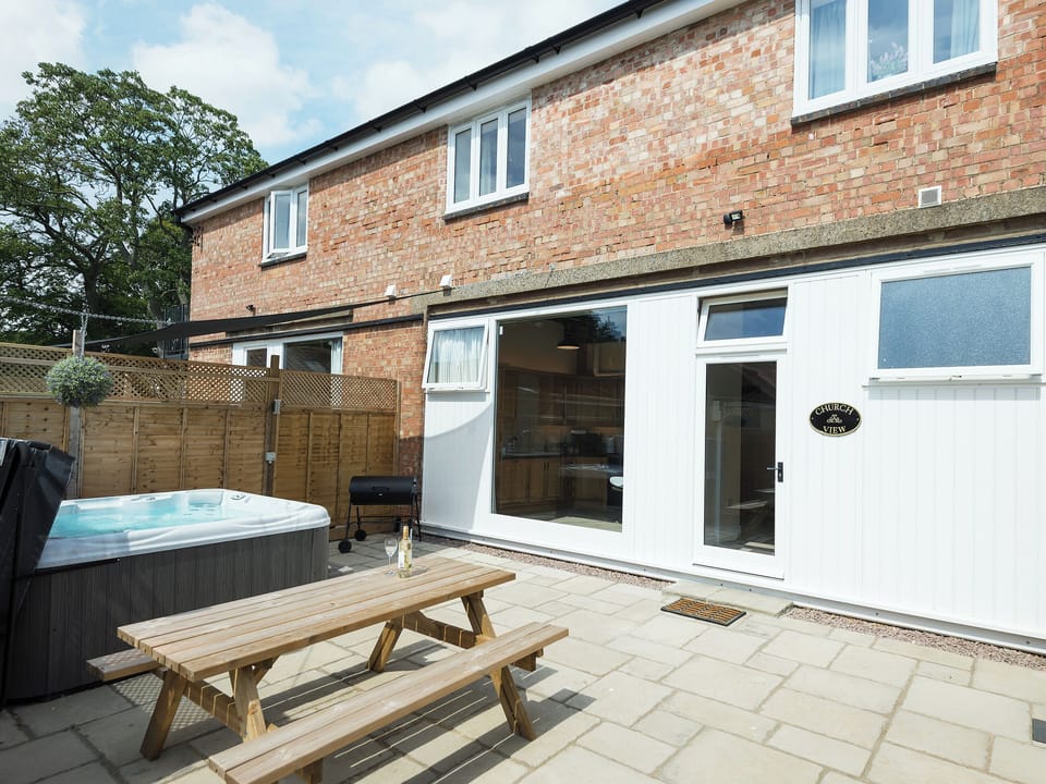 Impressive patio area with hot tub and BBQ | Church View - Riverside Barns, Wainfleet St. Mary, near Skegness