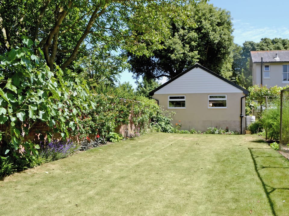 Garden with vegetable patches and seating areas | Stable Cottage, Littlehampton, near Arundel