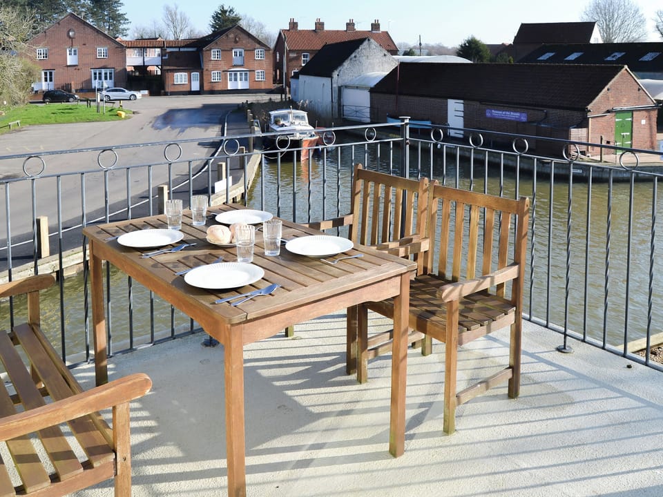 Veranda with seating area | Solace - Norfolk Riverside Cottages, Stalham